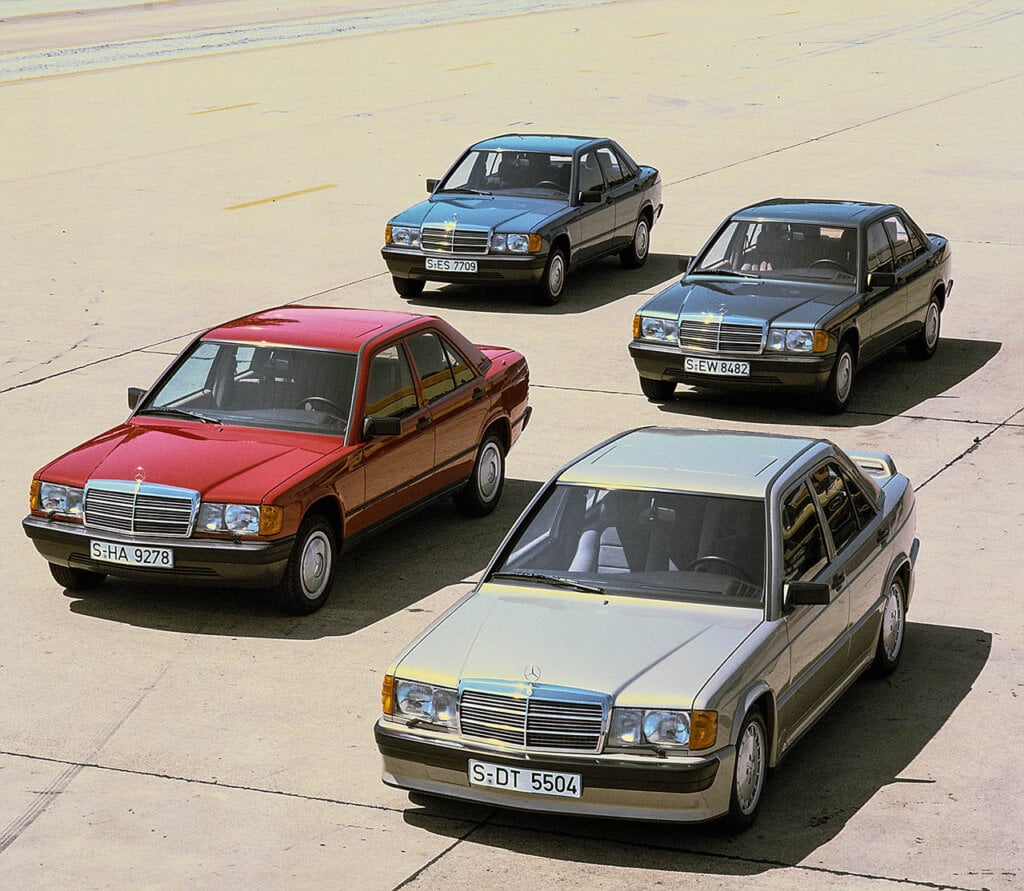 group of Mercedes compact class of the 201 model series in a parking lot