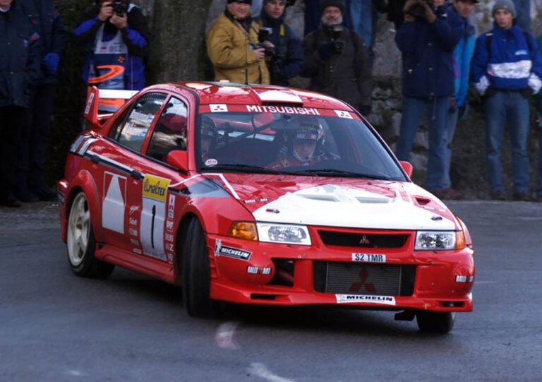 T.Mäkinen drifting in a red Mitsubishi Lancer Evo