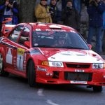 T.Mäkinen drifting in a red Mitsubishi Lancer Evo