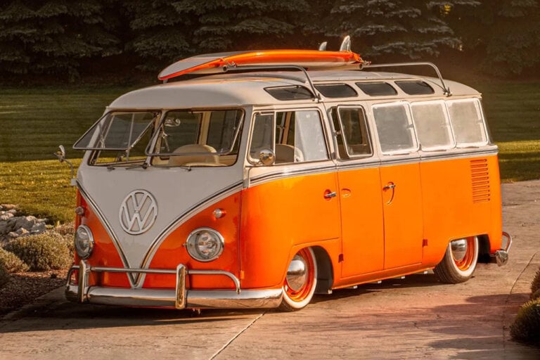 Orange VW Type 2 bus with surfboard