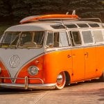Orange VW Type 2 bus with surfboard