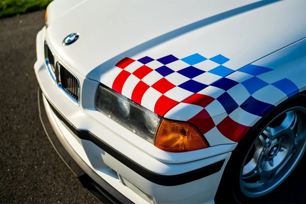 BMW Lightweight e36 m3 with checkered livery on hood of the car