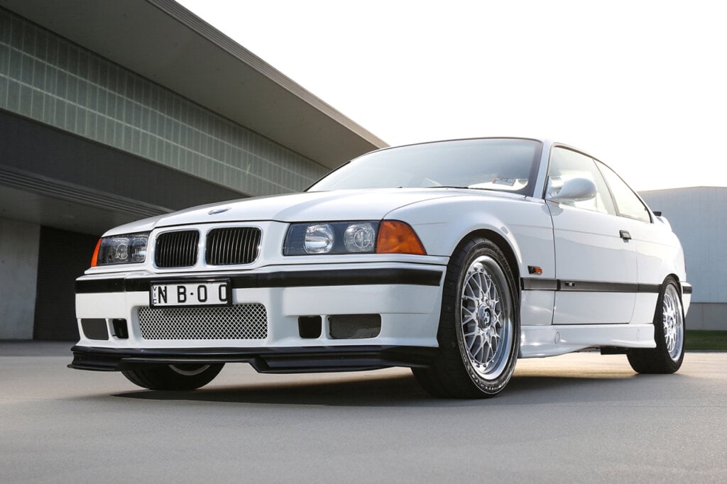 White BMW M3-R parked infront of a garage