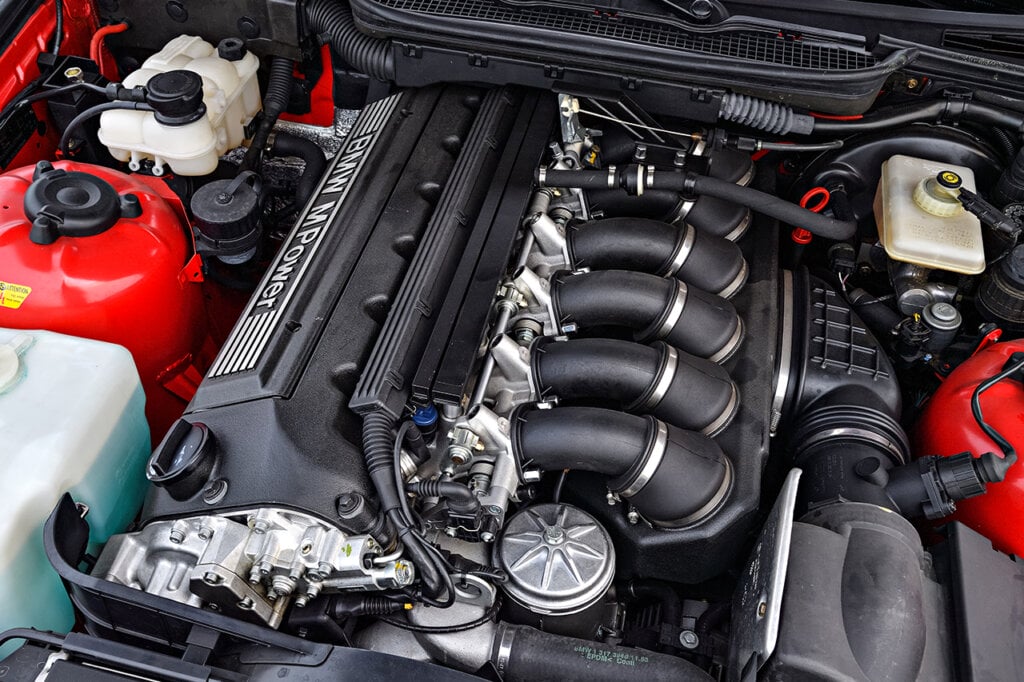 E36 M3 engine sitting in a red BMW car