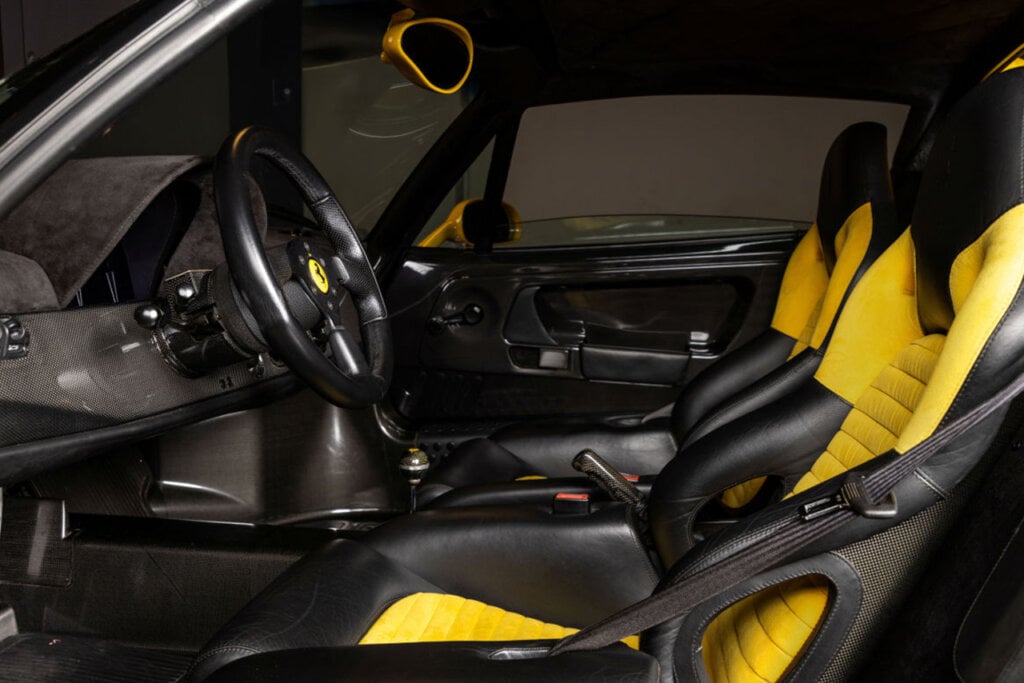 Ferrari interior with yellow and black leather seats and alcantara suede inserts and carbon fiber dashboard