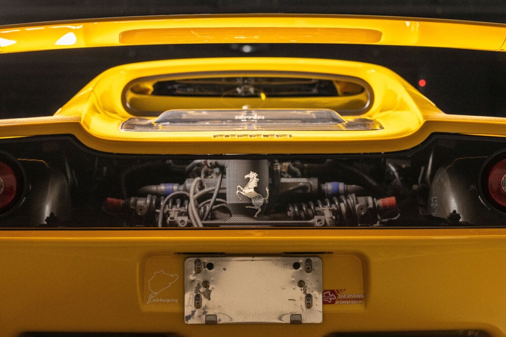 Rear V12 engine of a yellow Ferrari F50