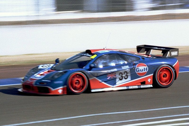 Blue and red McLaren F1 on racetrack