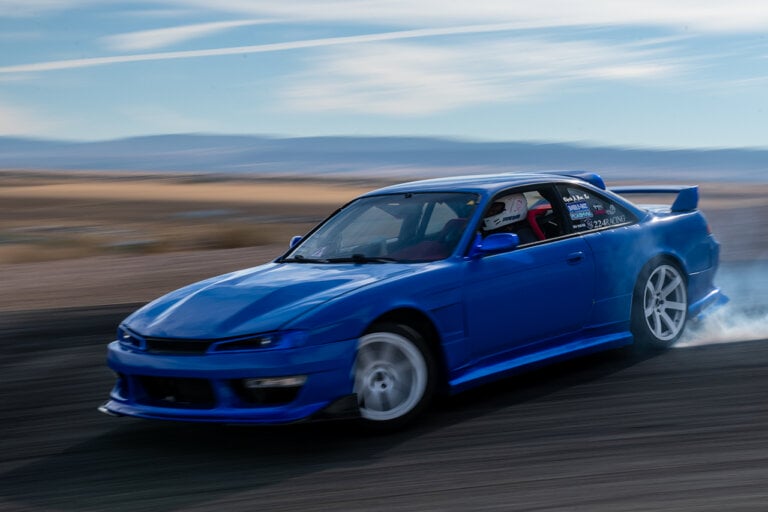 Blue Kouki S14 drifting through a turn