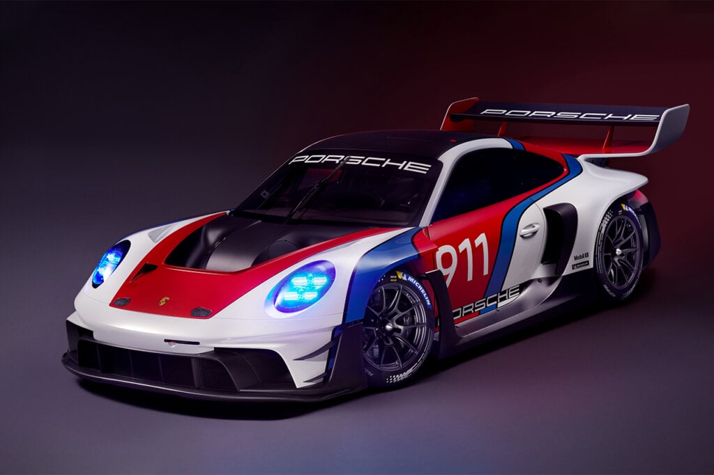 Porsche car parked at an angle in a dark room