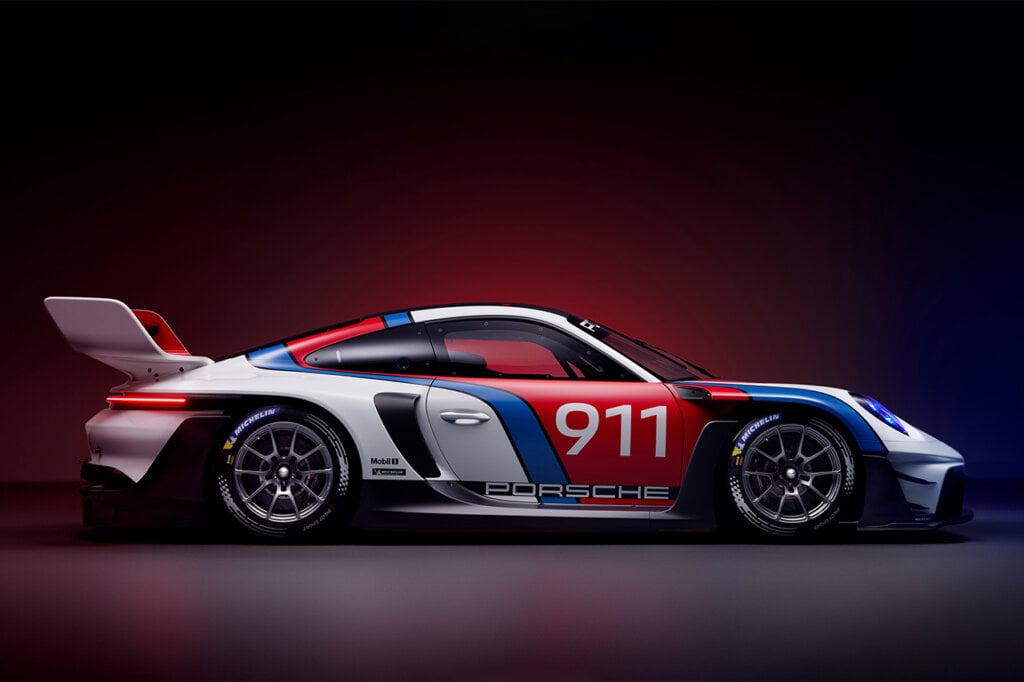 side profile of the Porsche 911 GT3 R Rennsport car on a black background with red light fading into it