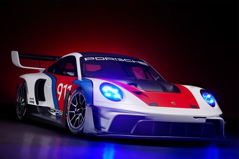 Red, white, and blue Porsche 911 GT3 R Rennsport edition Porsche on a dark background with blue and red accents