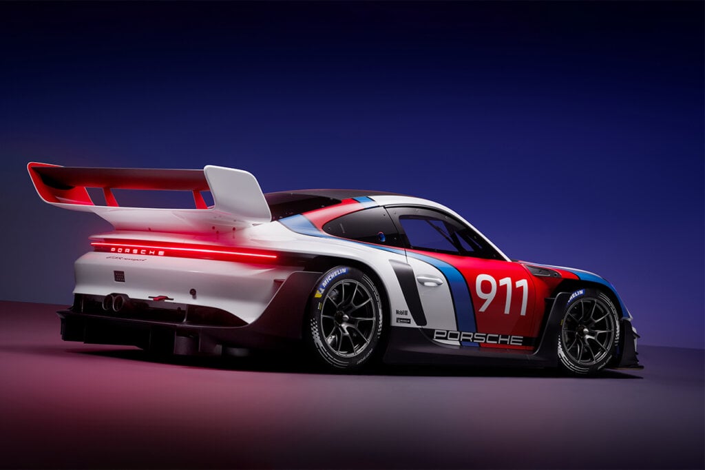 Porsche 911 GT3 R parked at an angle with blue light fading in the background