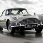 continuation programme aston martin db5 on a wet road