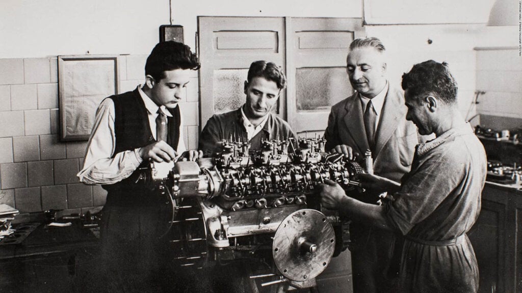enzo and dino ferrari looking at an engine