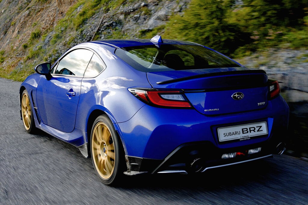 Rear side of the Subaru BRZ Touge Edition driving near a grassy mountain side