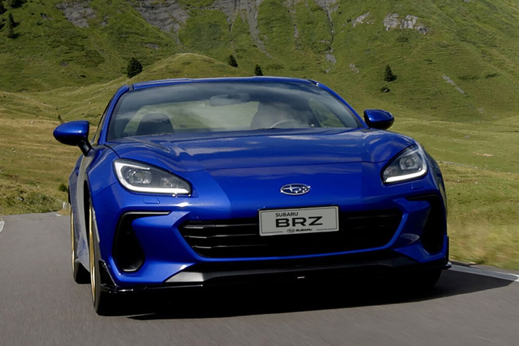 Blue BRZ Touge Edition car driving through a grassy mountainside