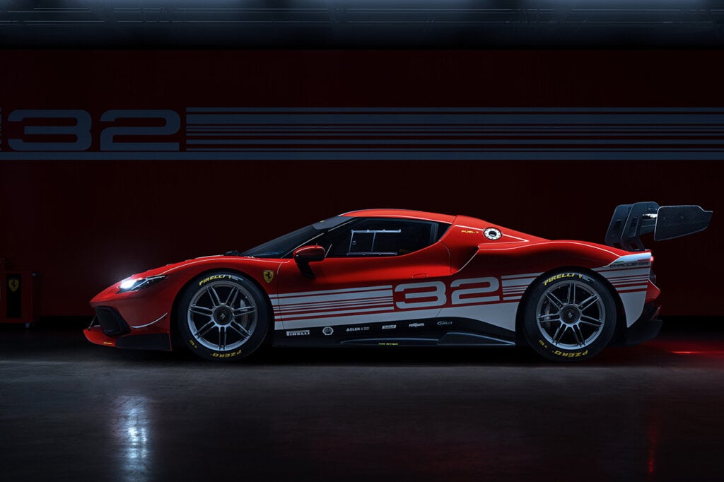 Side shot of a red Ferrari 296 Challenge next to a wall with 2 with white stripes