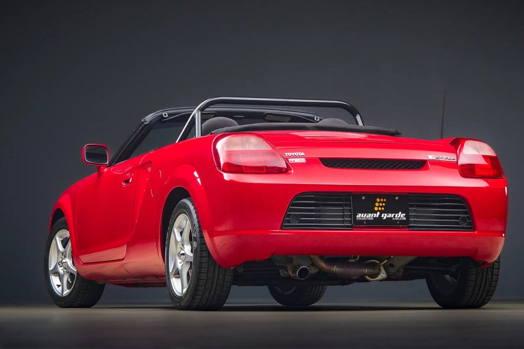 Rear view of a Red Toyota MR2 on black background