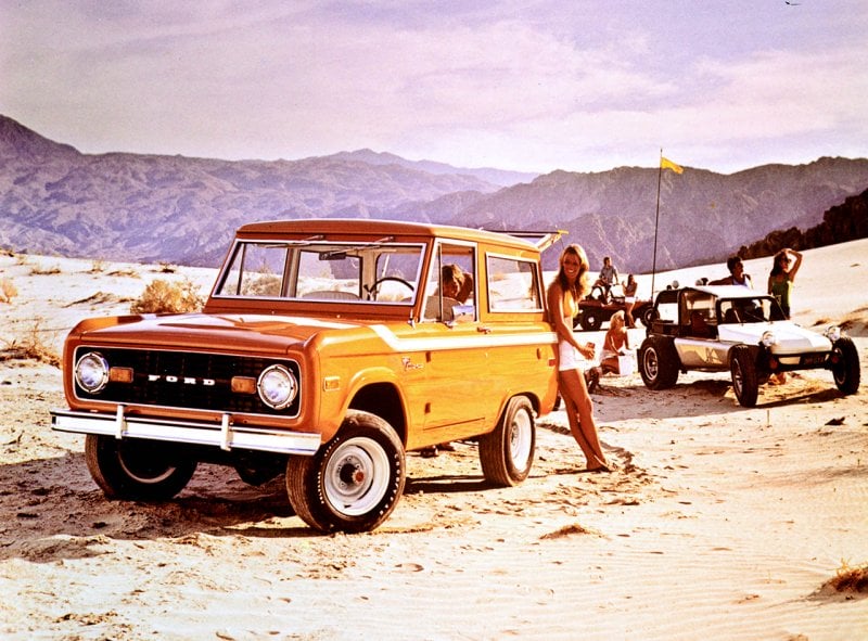 yellow 1976 ford bronco at a desert