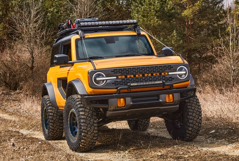 yellow bronco base model trekking trough a forest