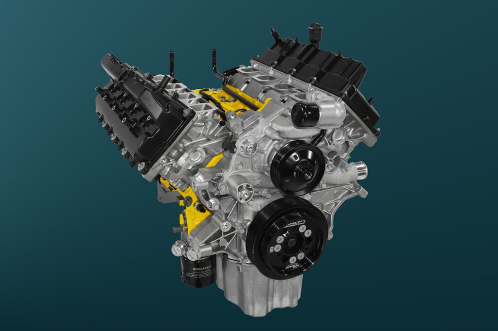 Black and silver Dodge engine on green and black background
