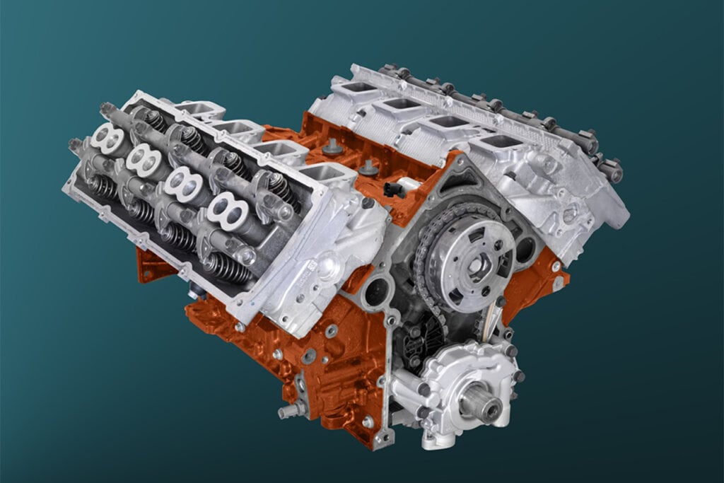 Silver and Orange HEMI engine from Dodge on green and black background