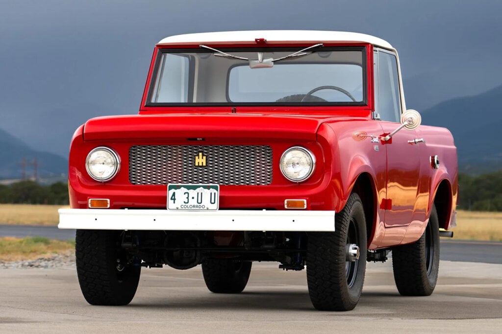 Red International Harvester Scout 80 with dark sky and mountain in background