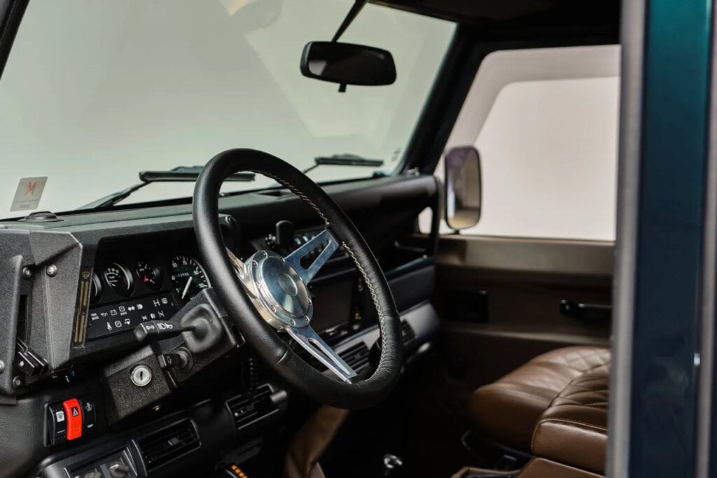 Interior shot of a Land Rover Defender, custom steering wheel and seats