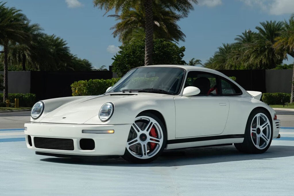 White 2024 RUF SCR parked in front of a palm tree and on bluish grey ground