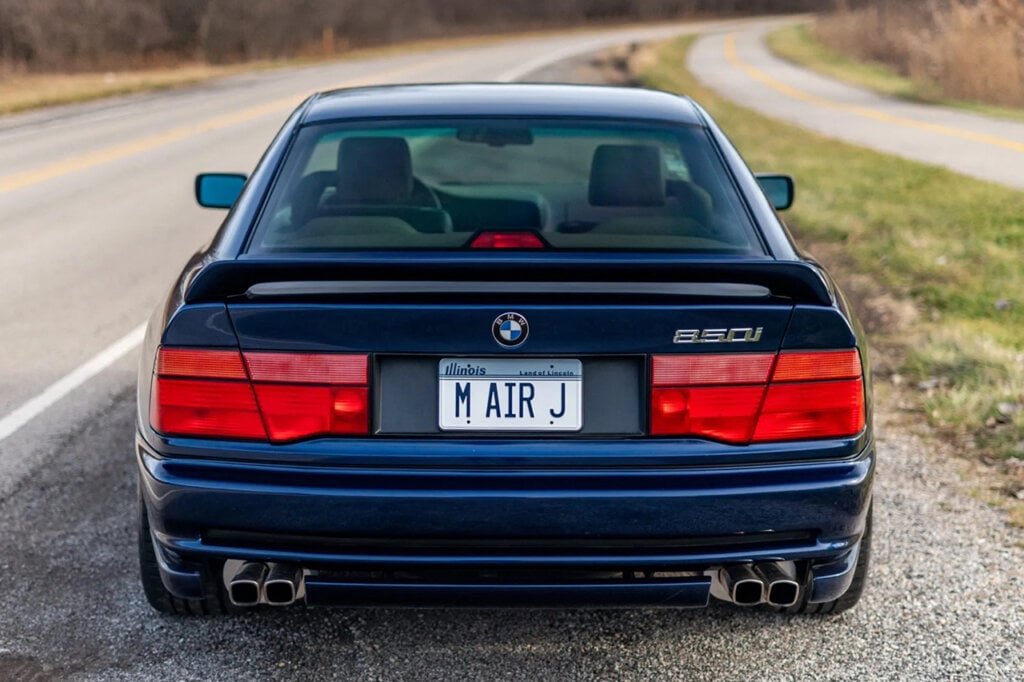 rear shot of a Blue E31 that says M Air J on license plate