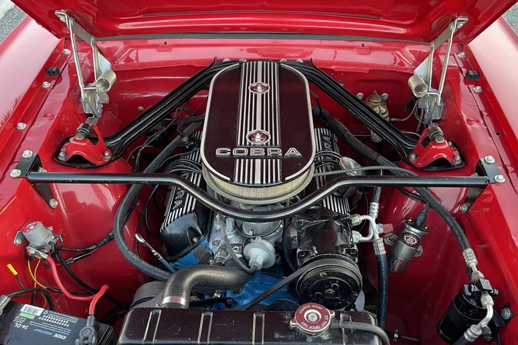 Red Ford Mustang powered by a V8 engine with a Cobra Air Filter on the top of the engine block