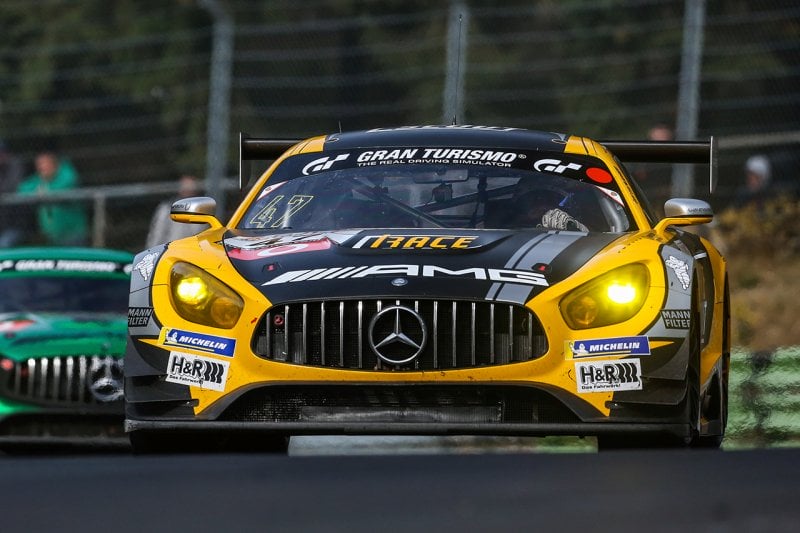 Yellow AMG GT coupe race car driving on a race track