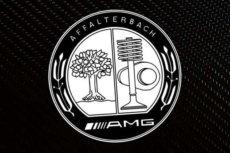 Black and white logo mark of AMG's former logo on a textured background