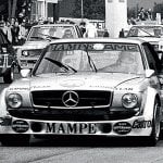 black and white photo of Mercedes 450 SLC AMG coupe in a race