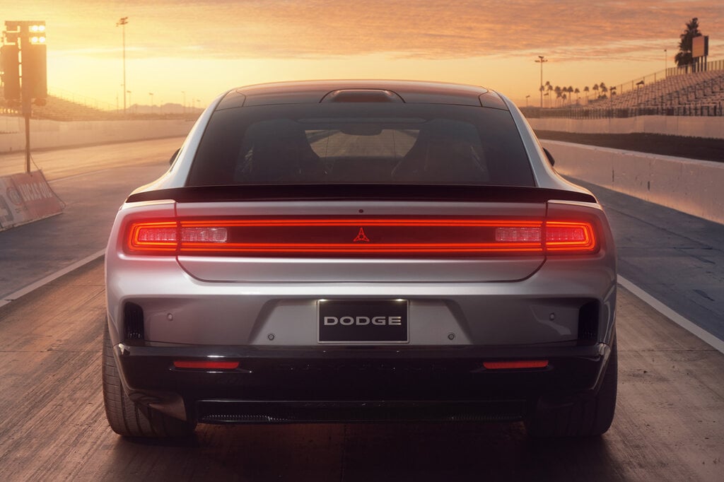 Silver Charger rear taillights on a race track with sunset in background