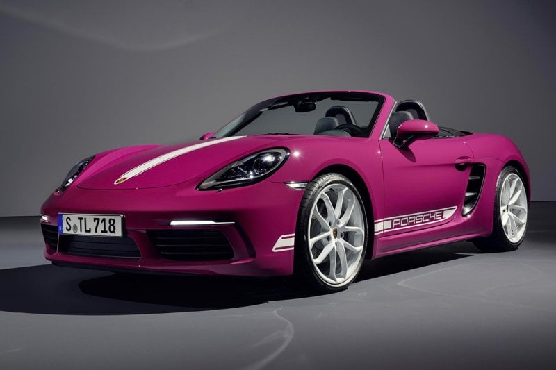 Pink Porsche 718 vehicle on a dark grey background parked at an angle