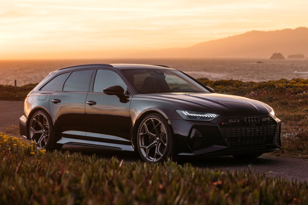 Black RS6 parked with a sunset background