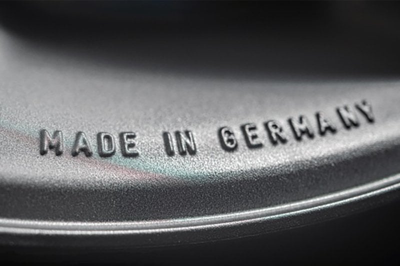 lettering stamped on the side of a metal wheel that says "Made In Germany"