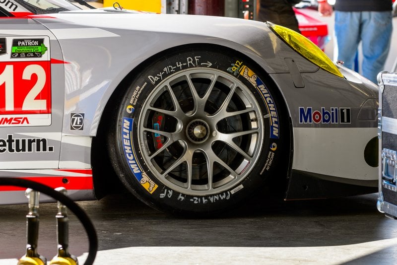 Porsche 911 race car with BBS wheels with Michellin tires parked in a garage