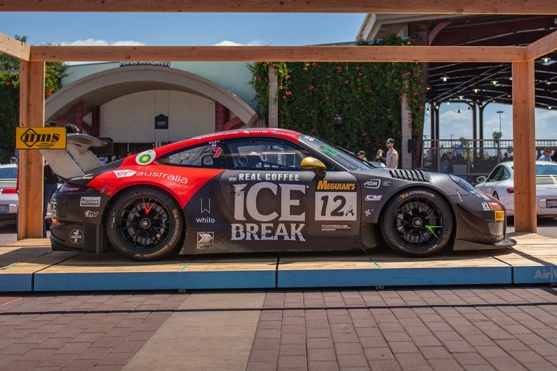 Black and red Porsche 911 gt3rs race car with number and words on the door
