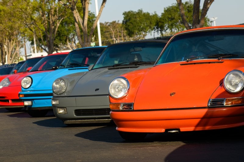 Orange, grey, blue and red 911s parked next to one another