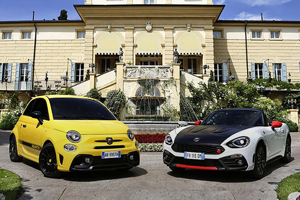 Yellow and white and black Fiat Abarth vehicles staged next to one another