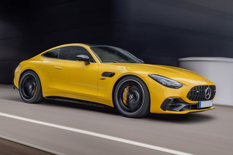 Yellow Mercedes AMG GT Coupe driving on a road