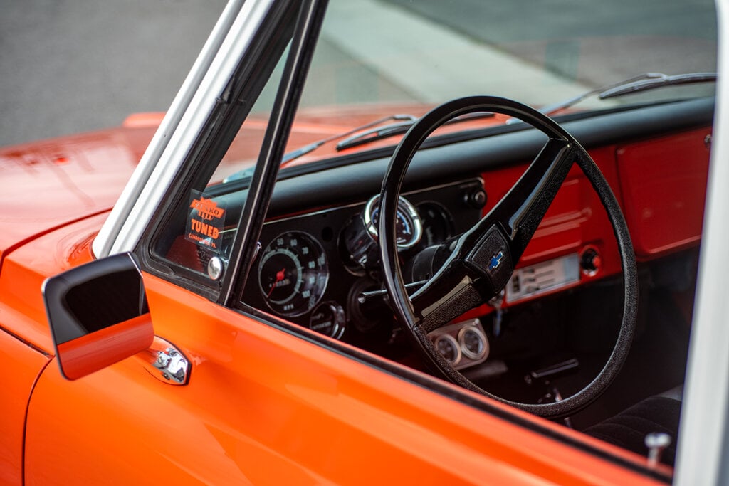 interior shot of a steering wheel of an orange truck