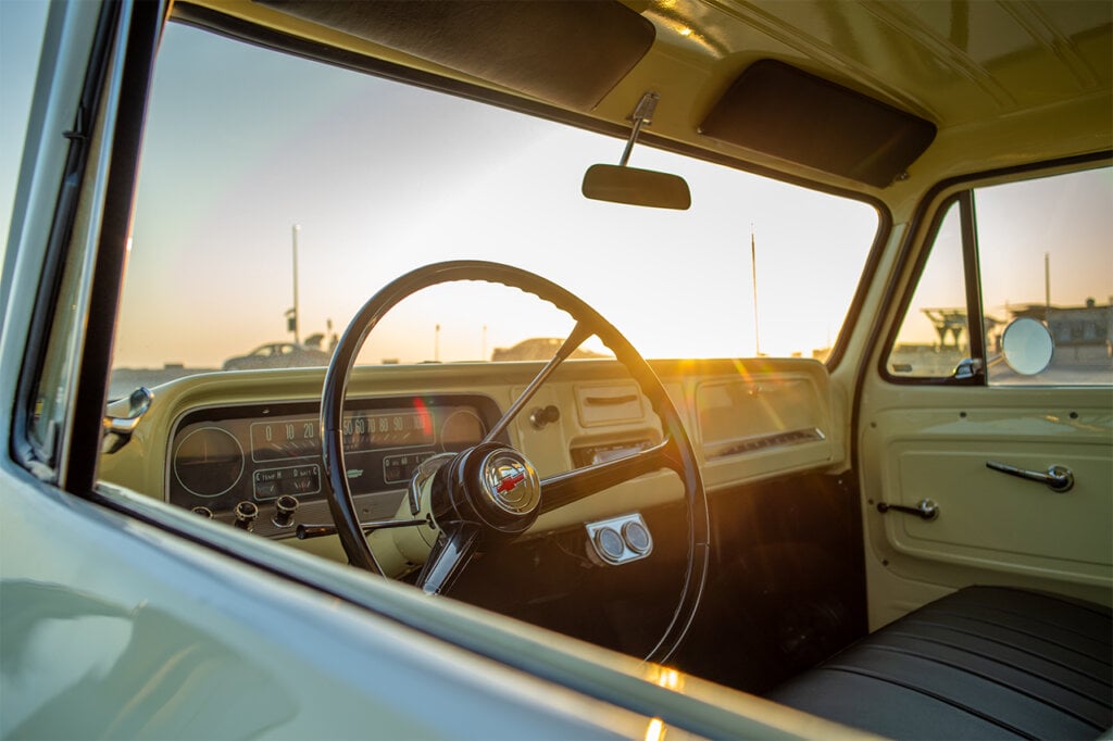 Interior of a yellow C10 with sun setting in the background