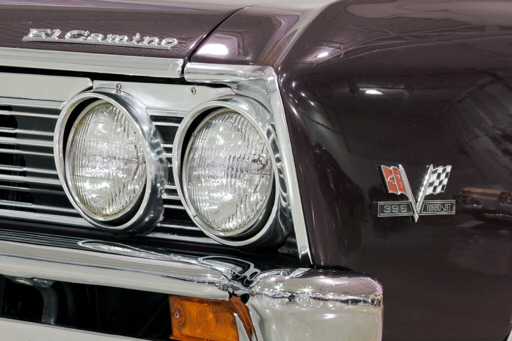 Close up of chrome headlights and the chevy flag emblem