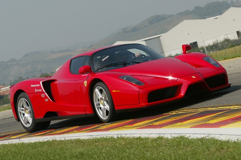 Ferrari Enzo sports car driving on a racetrack