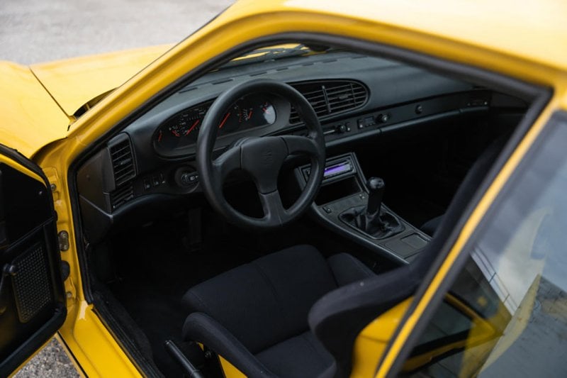 Black interior of yellow Porsche 968