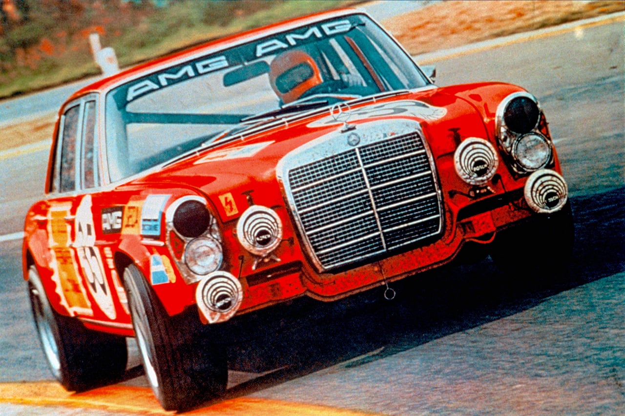 Red race car with AMG decal on windshield taking a turn