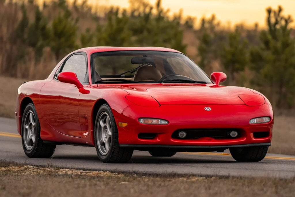 Red Mazda Rx7 FD parked with the sunsetting in the background